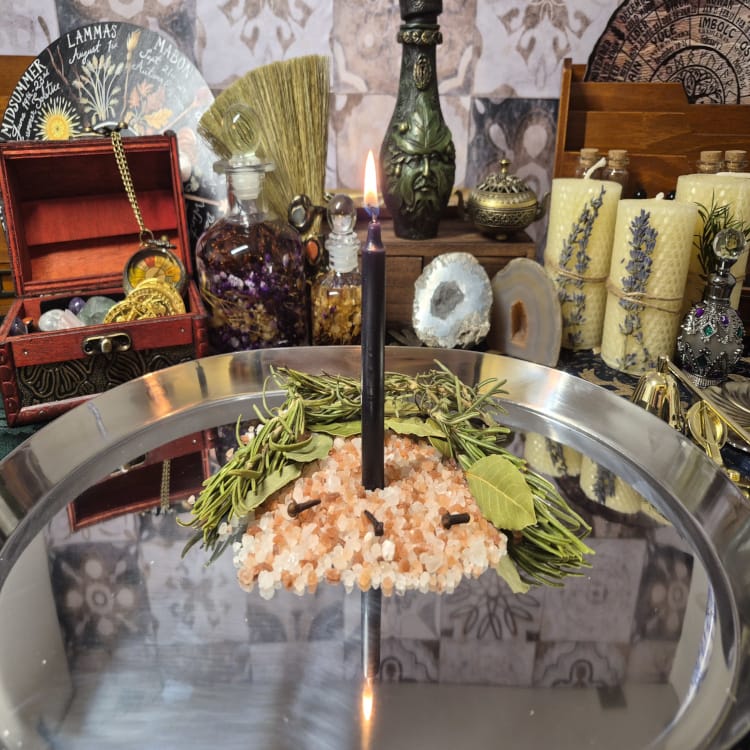 Black candle ritual with herbs and crystals for protection and manifestation