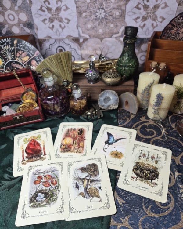 Tarot reading setup with cards, candles, crystals, and ritual tools