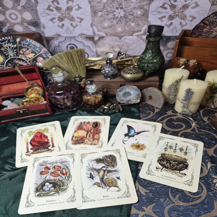 Tarot reading setup with cards, candles, crystals, and ritual tools